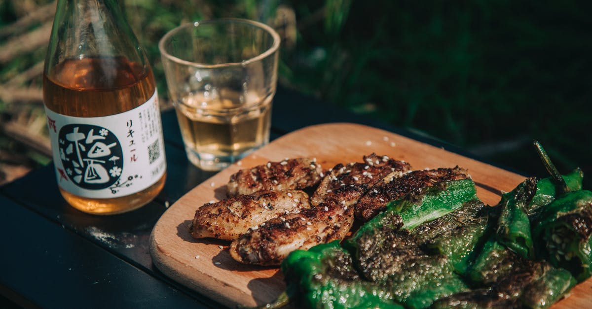 its harmful to eat not very well cooked beef? - Grilled Meat on Brown Wooden Plate Beside Clear Drinking Glass