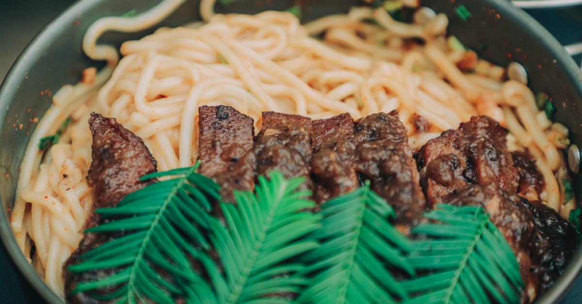 its harmful to eat not very well cooked beef? - Close-Up Photo of Noodle Dish