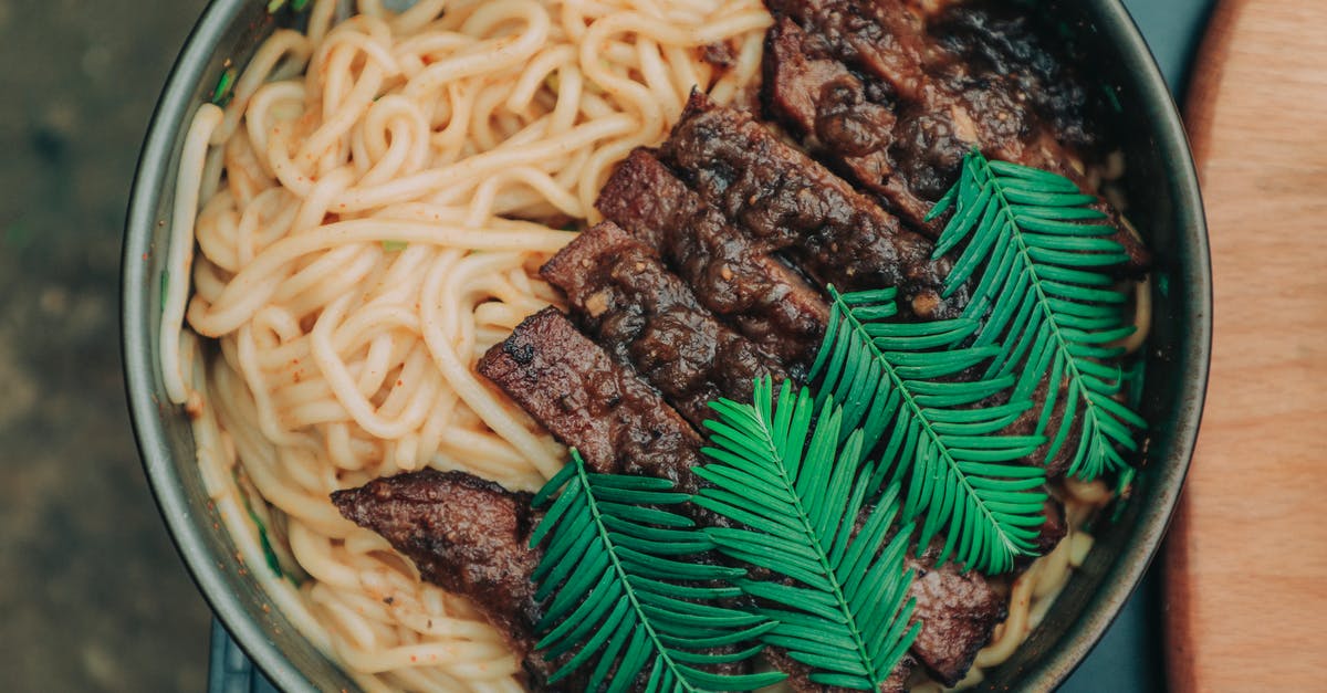 its harmful to eat not very well cooked beef? - Top View Photo of Noodles With Meat