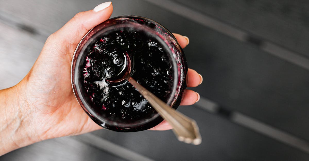 Jammed Jar Spigot - Person Holding Black and Red Round Container