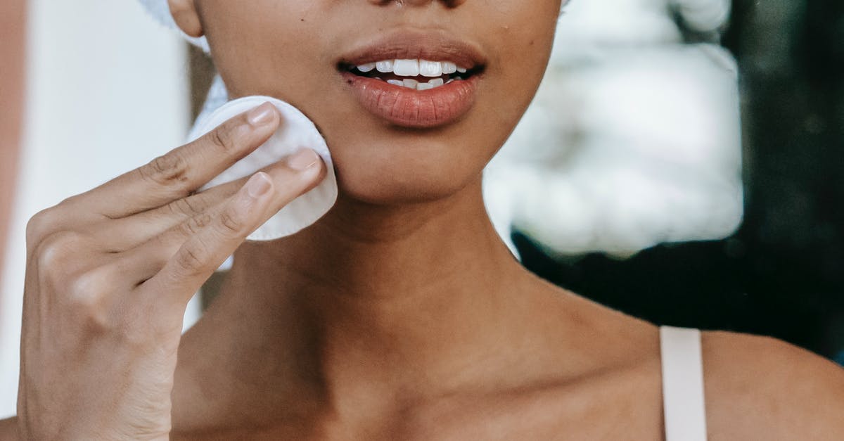 Japanese Cotton Sponge Cake - How to stop collapsing? - Crop anonymous ethnic female with pure skin touching cheek with cotton disk during daily routine at home