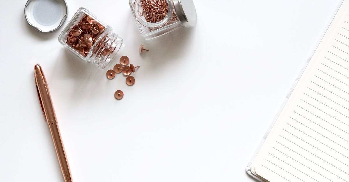 Jar lids popping several times - Bunch of Thumbtacks With Two Clear Glass Containers on White Surface