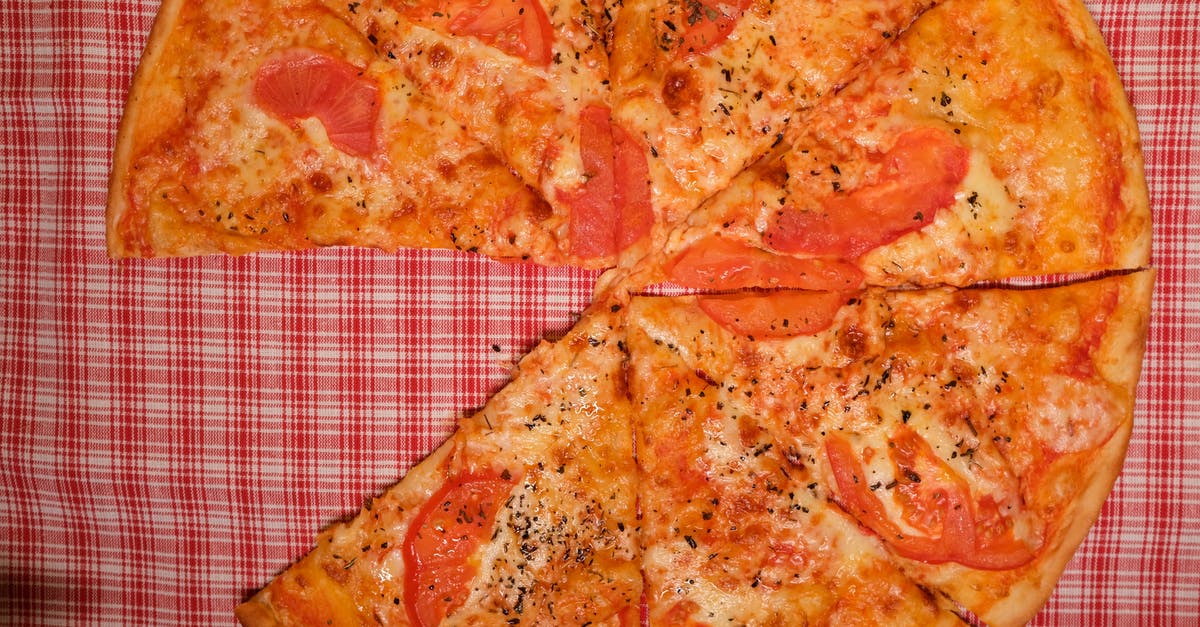 Keeping pizza crust from getting soggy from fresh tomatoes - Appetizing pizza placed on table in kitchen