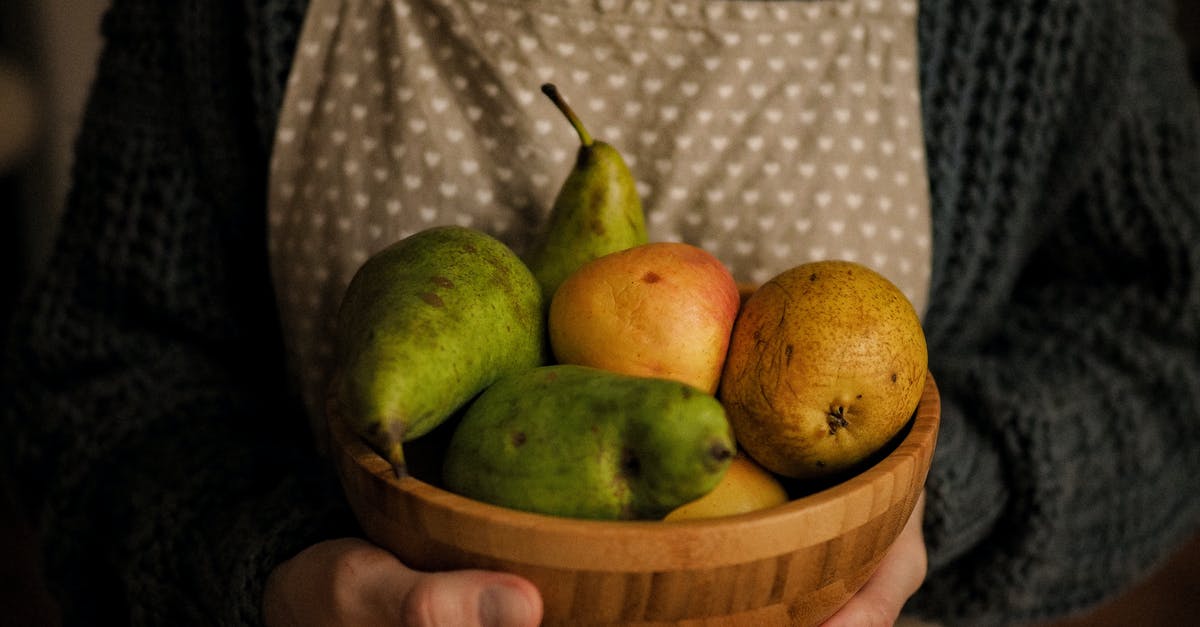 Keeping ripe pears for canning later - Person Holding a Wooden Bowl of Fresh Fruits