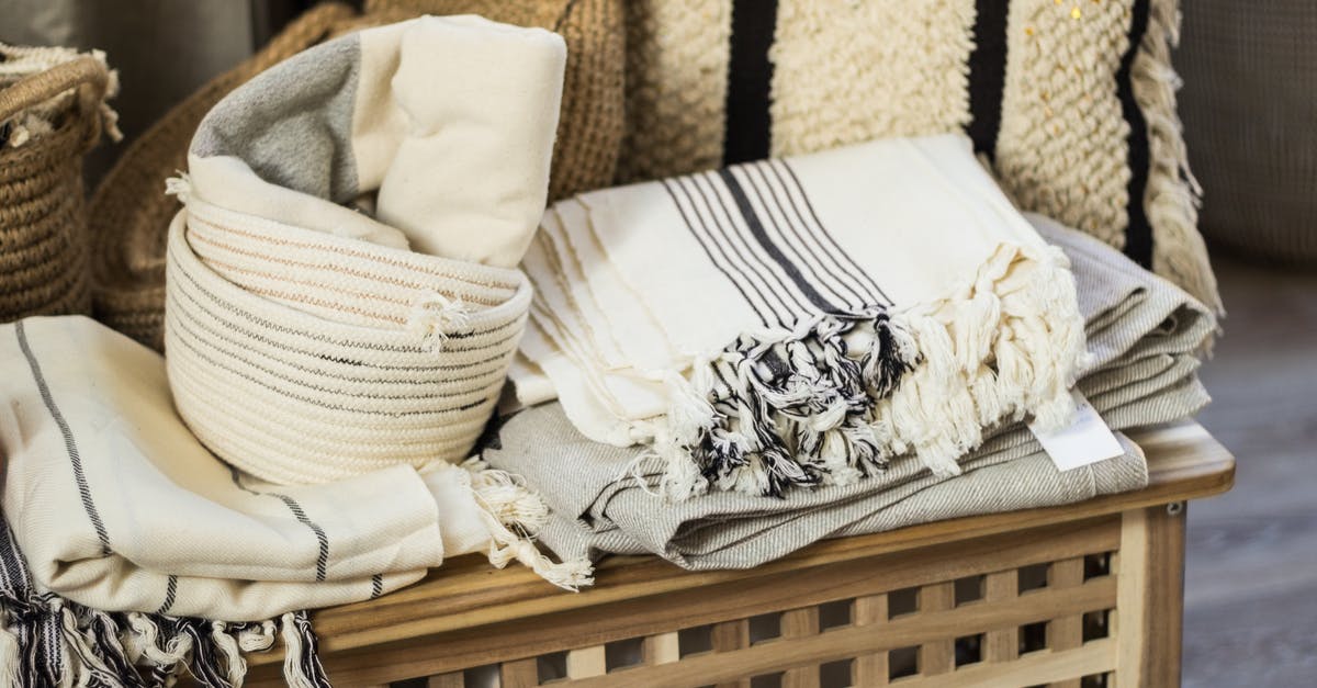 Keeping the grill grate clean and sanitary every time - Stacked towels and plaid on wooden box