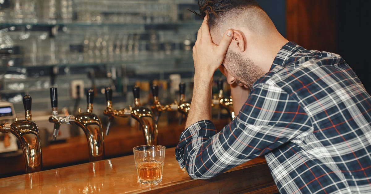 Kefir sensitivity to drinking tap water? - Man in Blue Dress Shirt Sitting Beside Bar Counter 