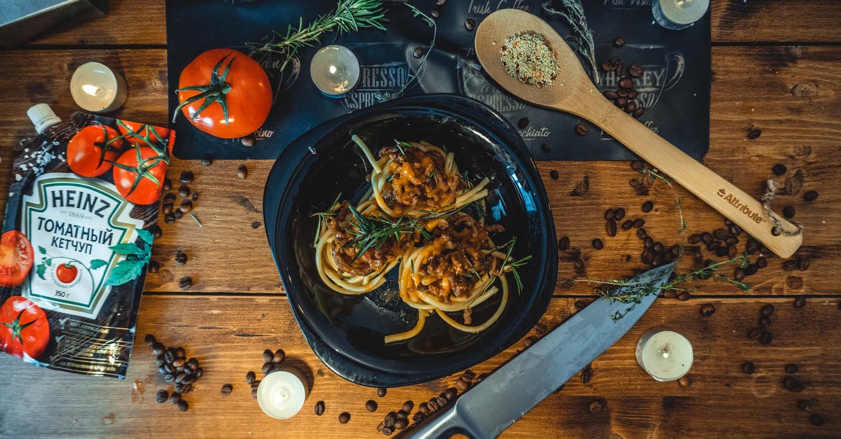 Key ingredients for classic Sauce Bolognese (Ragù Bolognese)? - Pasta Dish on Ceramic Plate