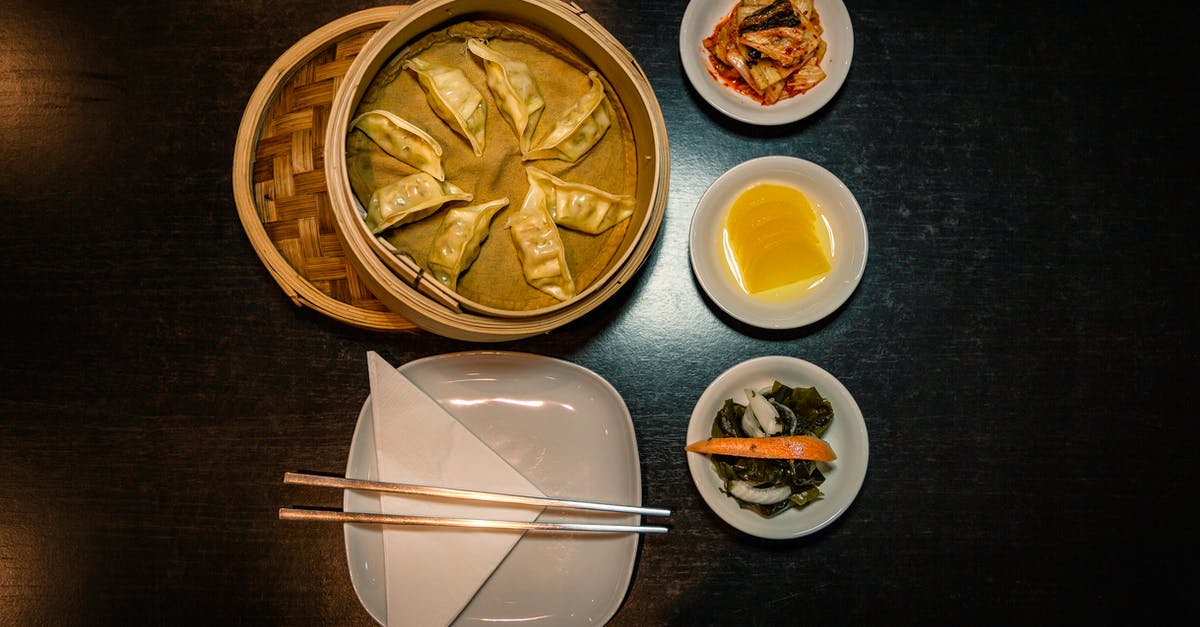 Kimchi / Mo-Chu Ka-roo? - Chopsticks on Plate Near Foods on Plates