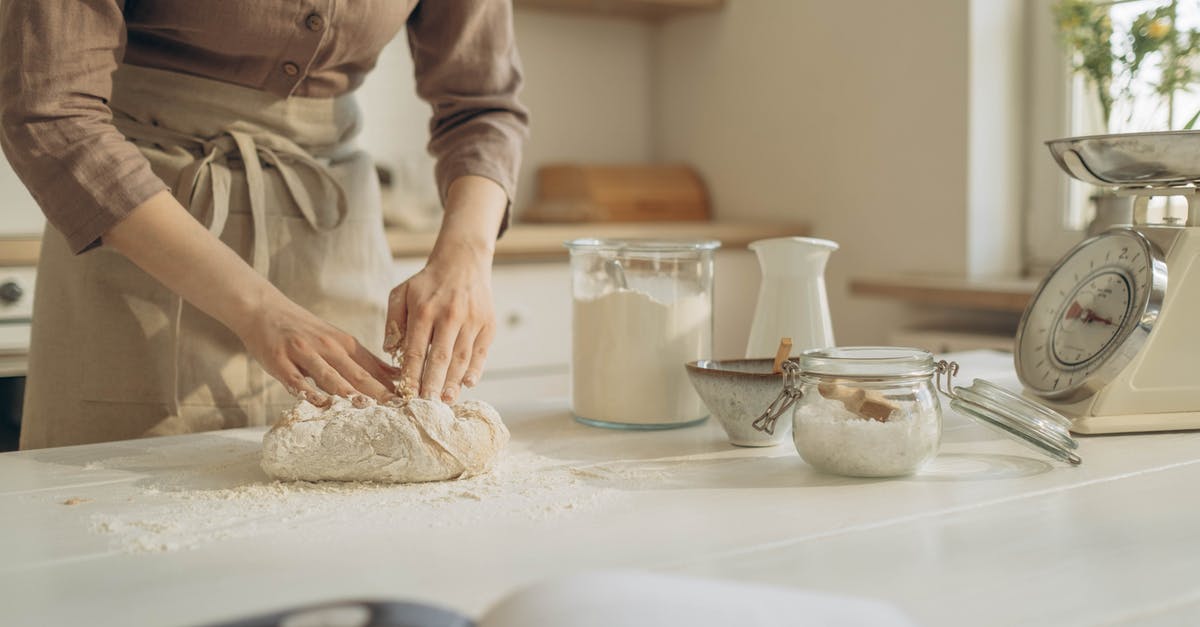 Kneading dough - significance of warm hands - Person in Brown Long Sleeve Shirt Holding a Dough