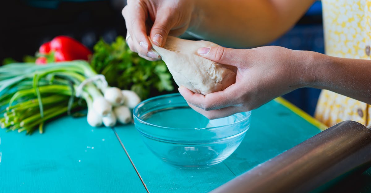 Kneading dough - significance of warm hands - A Person Holding a Dough