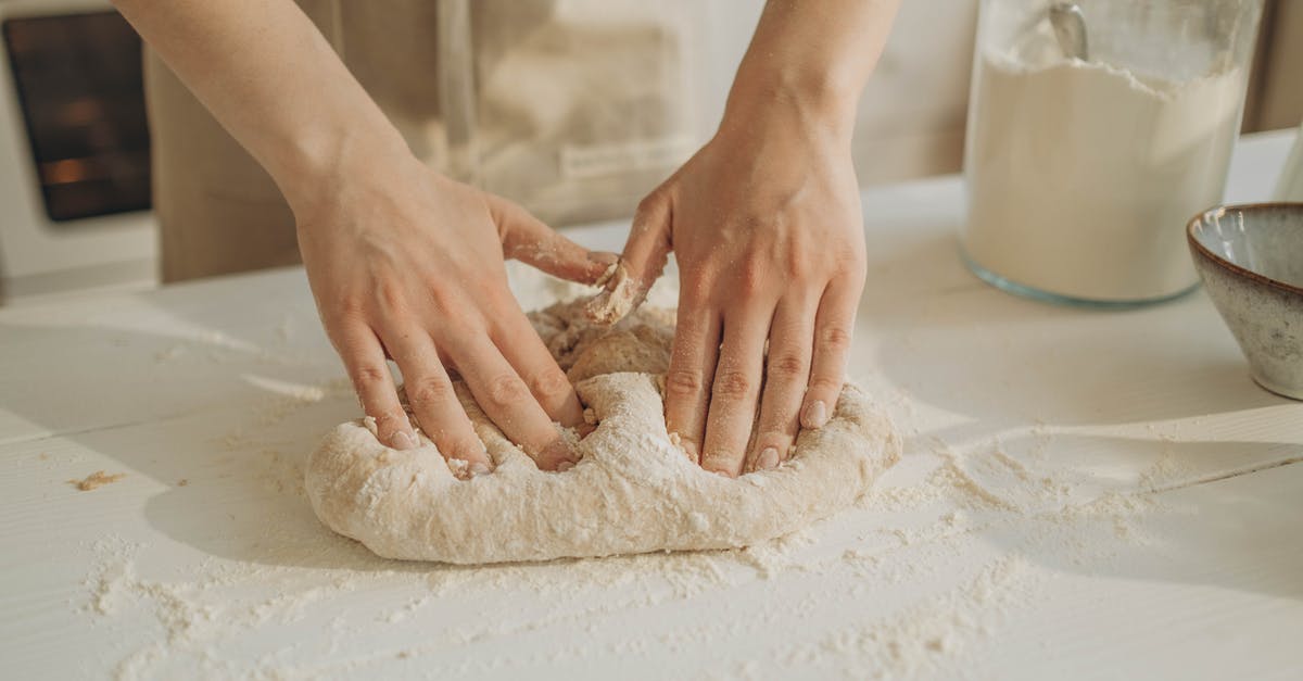 Kneading dough - significance of warm hands - A Person Kneading a Dough on the Table