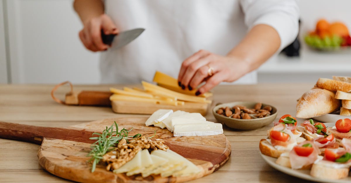 Knife chopping through bone or coconut - Person Slicing Cheese on Brown Wooden Chopping Board
