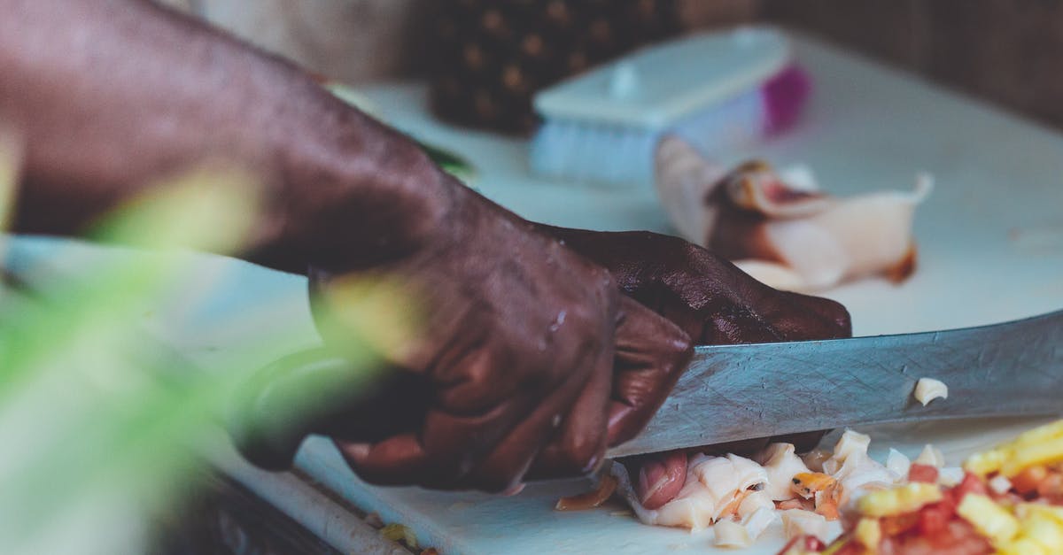 Knife chopping through bone or coconut - Man Chopping Vegetable