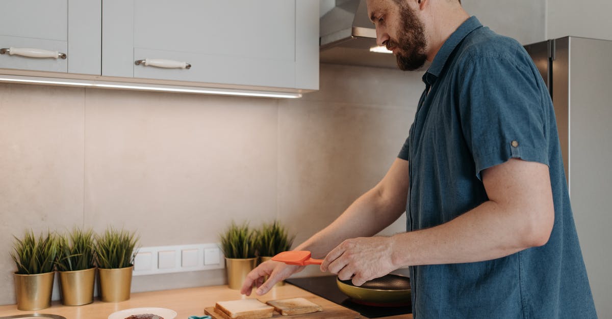 Lasagna in a sandwich maker - Man in Blue Crew Neck T-shirt Standing in Front of Brown Wooden Table