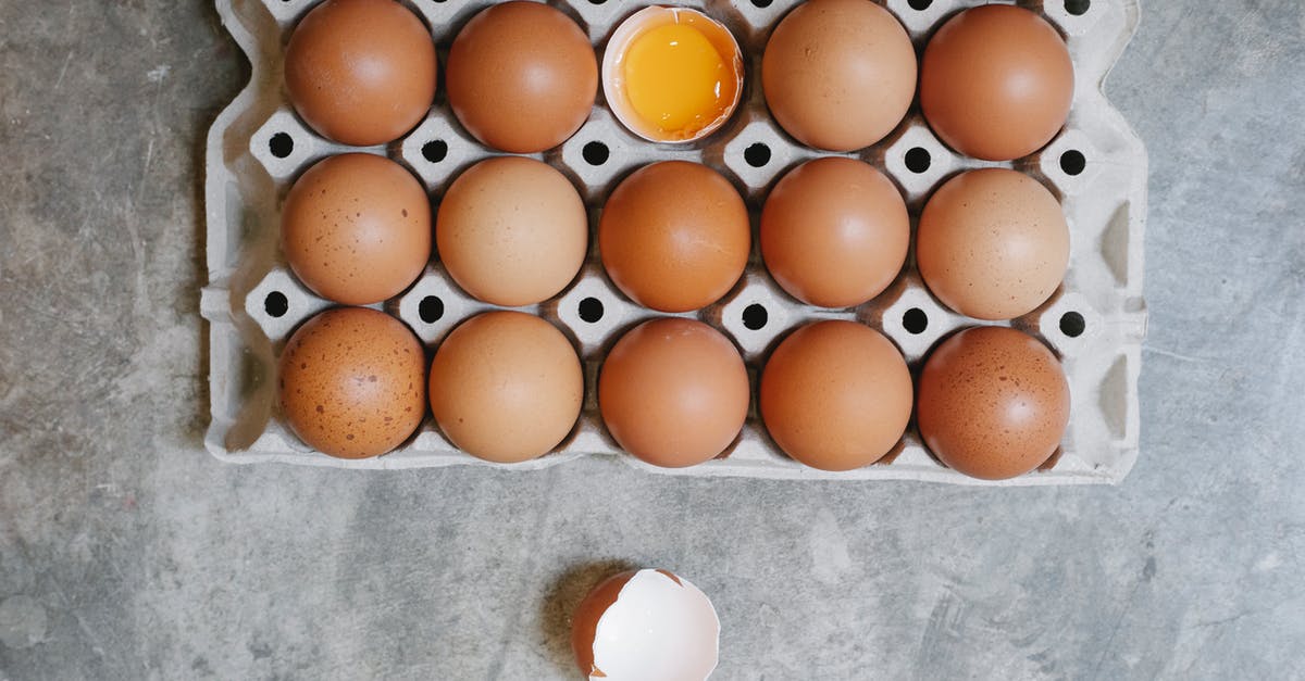 Lasagne package says cook from frozen - Top view of chicken eggs in rows in paper container placed on table for cooking