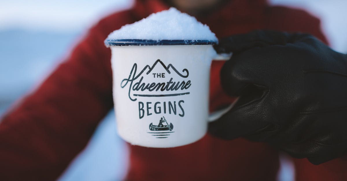 Le Creuset vs. Lodge Enamel - Selective Focus Photography of Person Holding the Adventure Begins Mug