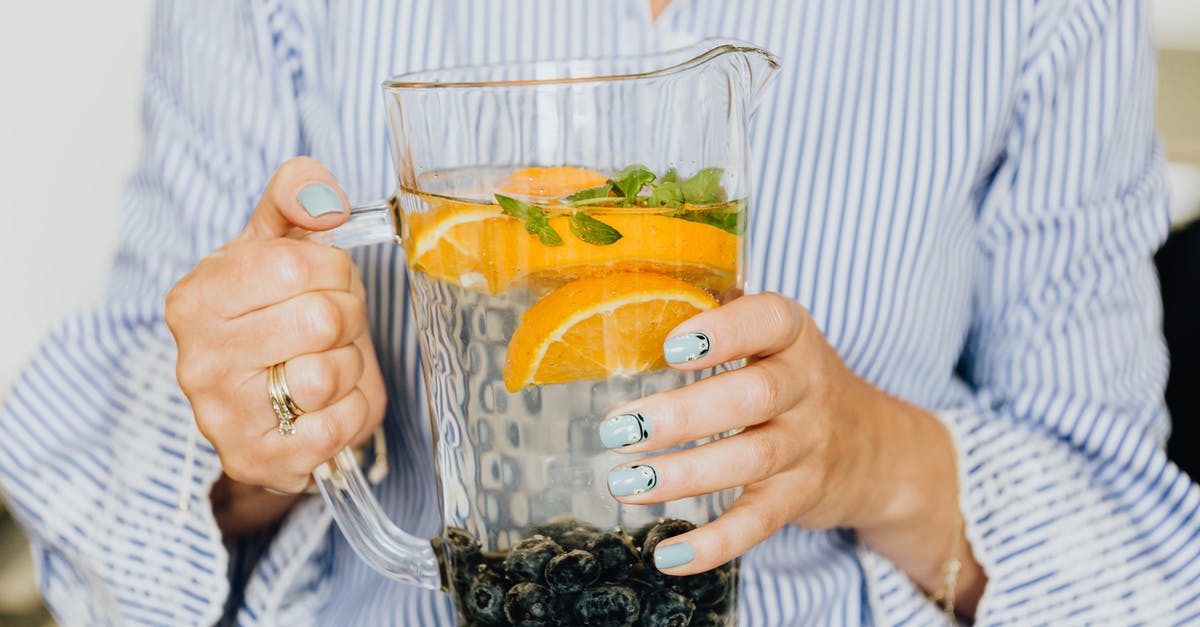 Lemon and Mint drink - Man in White and Blue Striped Dress Shirt Holding Clear Glass Mug With Lemon Juice