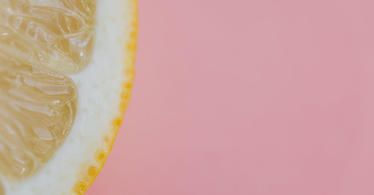 Lemon peel thickness - Top view flat lay composition of sliced lemon placed on pink background