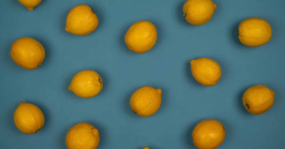 Lemon peel thickness - Overhead view of backdrop of whole ripe lemons with pleasant scent and pedicels on peel