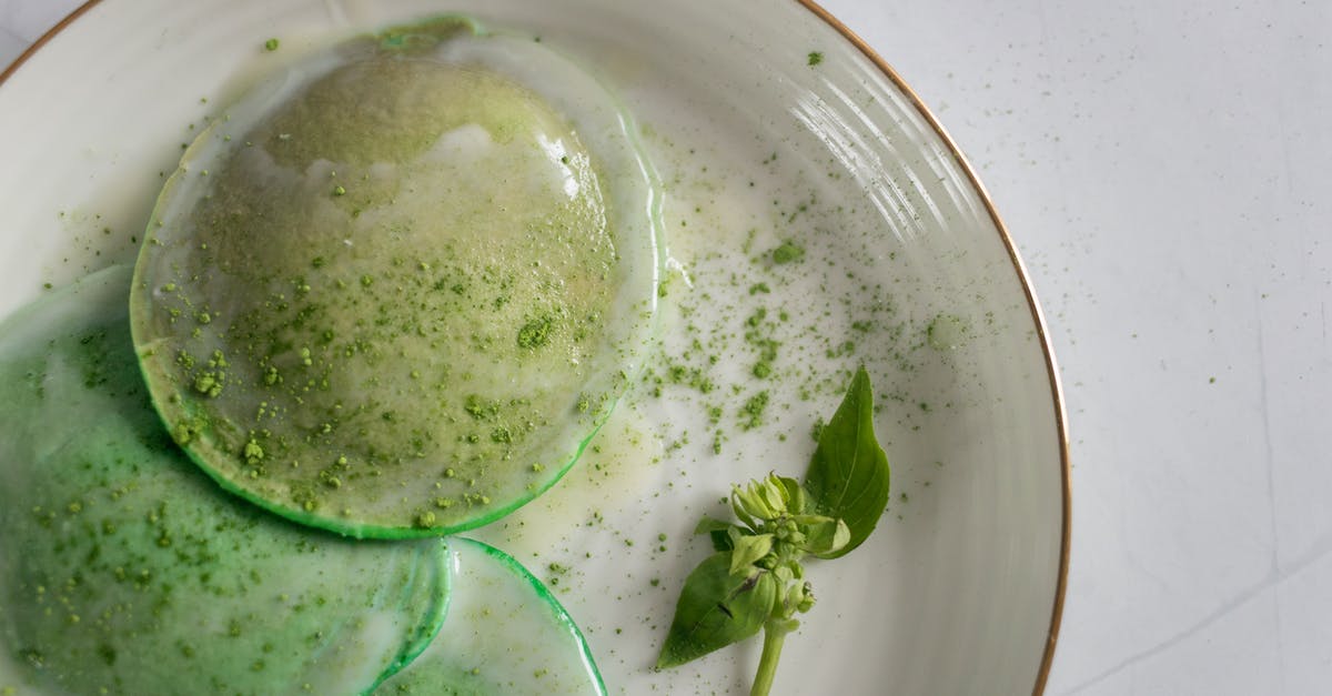Light green squash-like ingredient in Indonesian cuisine - From above of delicious poached egg decorated with green seasoning and herb with leaves on white plate on table