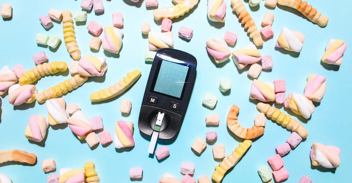 Liquid glucose in marshmallows - Glucose Meter Surrounded by Sweet Treats on a Blue Surface