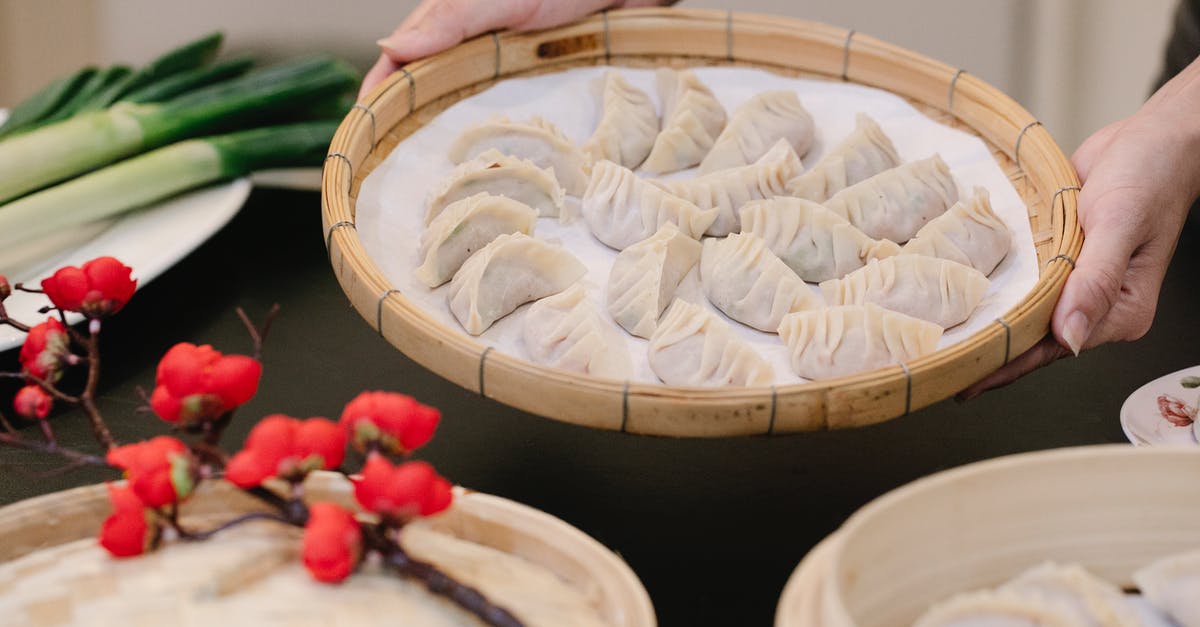 Looking for 10" bamboo steamer that will last! - Crop woman with delicious dumplings in bamboo tray at home