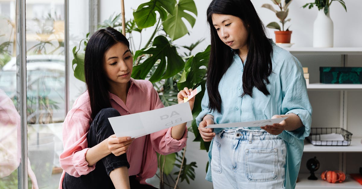 looking for edible paper - 2 Women Holding White Printer Paper