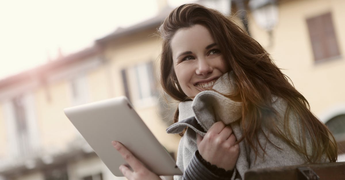 Low tech strategies for keeping food warm - Smiling woman messaging on tablet in city