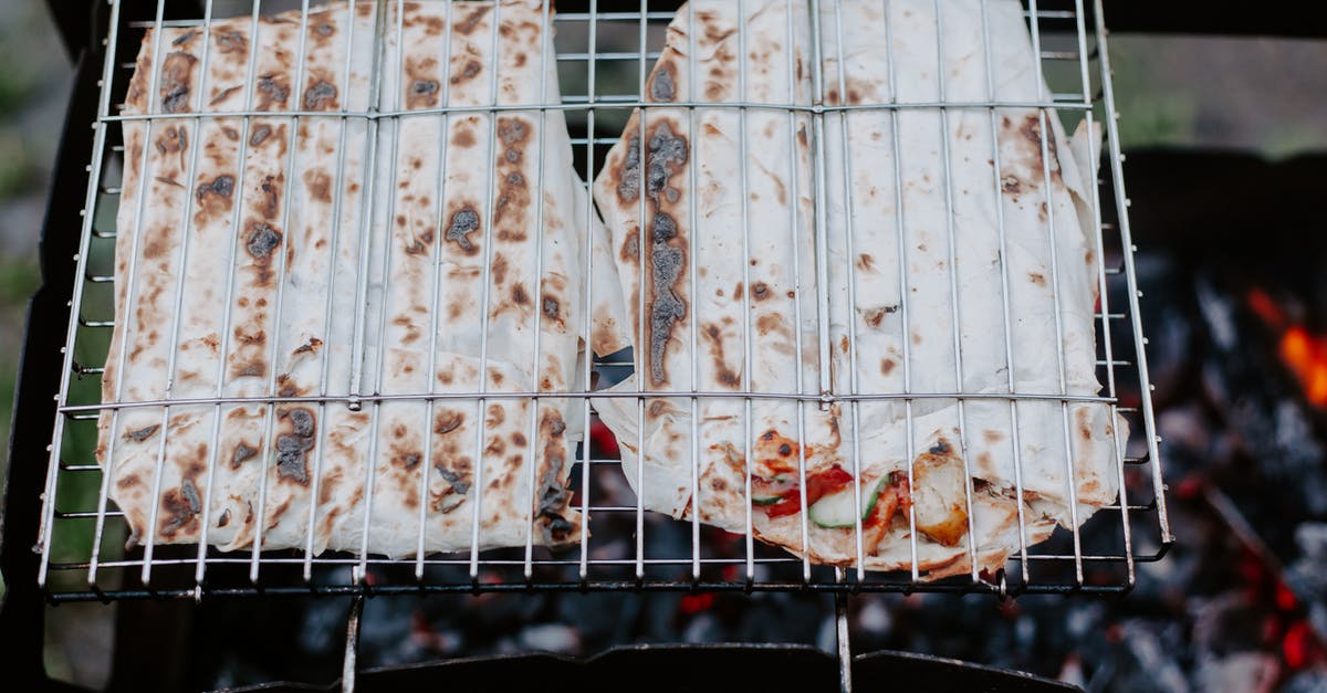 Lunch meat is slimy on outside? - From above of appetizing meat and vegetables in lavash grilling on metal grate in daytime