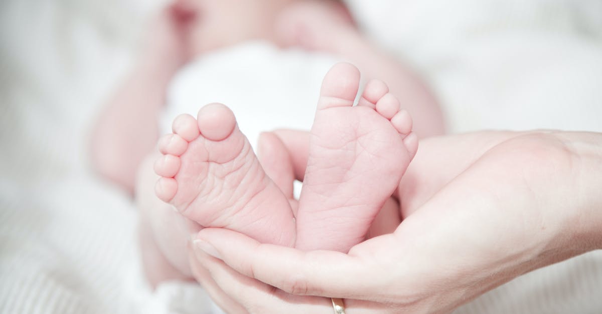 Macaron Help - Hollows and Little Feet - Close-up of Hands Holding Baby Feet