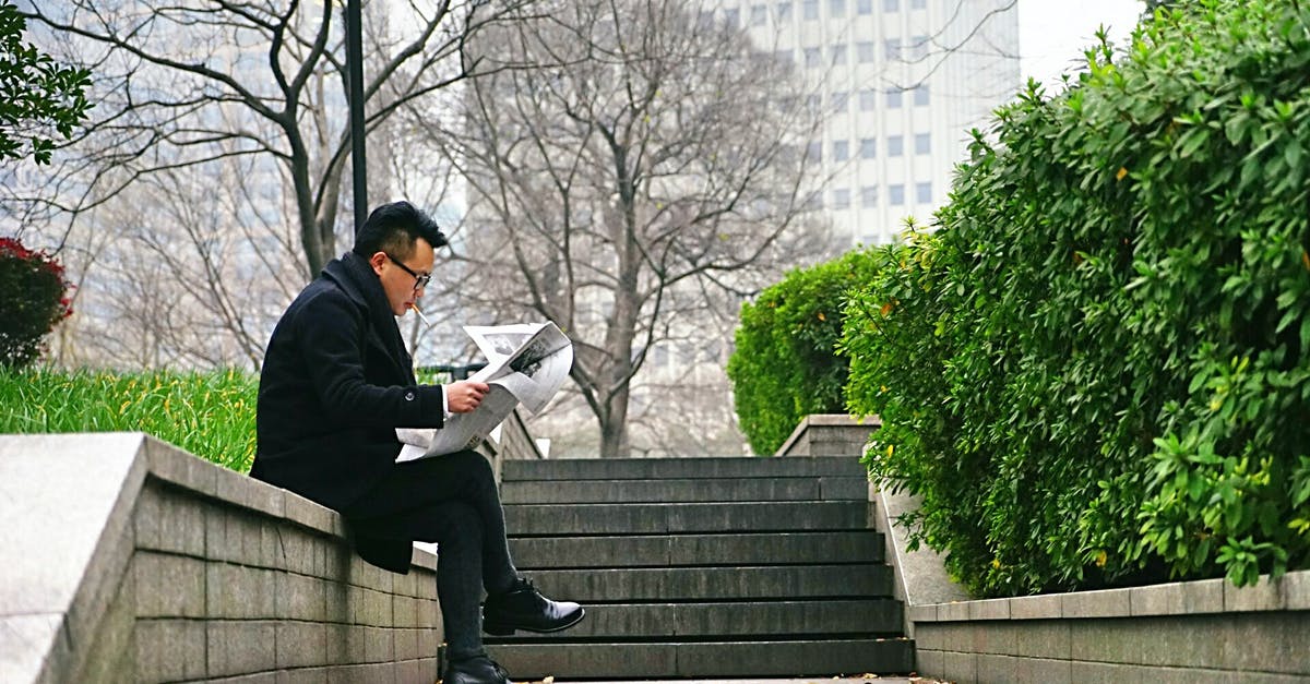 Mackerel brining time before smoking - Man Reading Newspaper Sitting on Stair Wall