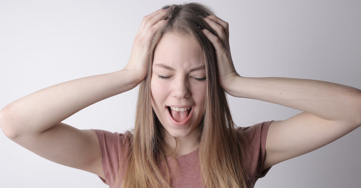 Maillard Reaction at Higher Pressures - Angry crazy female in casual pink t shirt touching head while being unhappy and shouting loudly against gray wall background