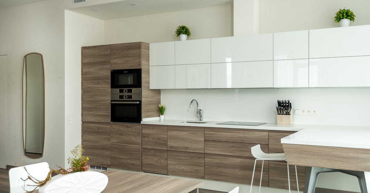 Make microwave popcorn in the oven - Spacious kitchen with modern furniture and appliances in minimalist apartment