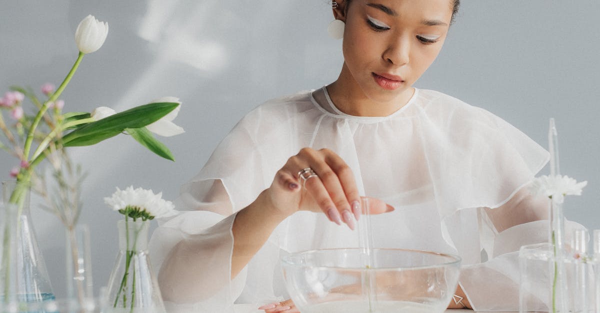 making a sourdough starter in desert like conditions - Woman in White Making Table Arrangement Looking Like Science Laboratory