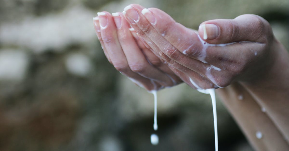 Making clarified butter by removing water but not the milk solids? - Person's Hands Covered in White Liquid