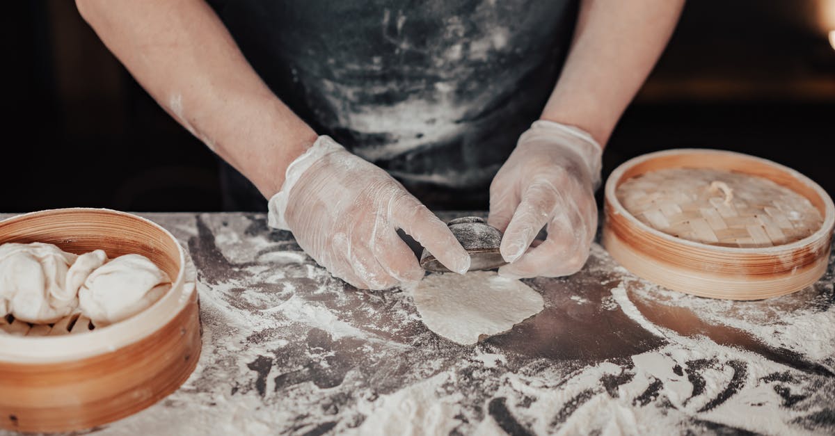 Making doughballs (dumplings) with strong brown flour and shredded suet - A Person Making a Dumpling while Wearing Gloves