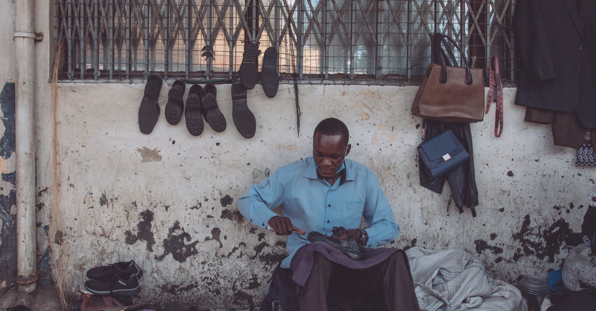 Making large quantities of tea with bags - Man in Blue Shirt Sitting on the Street Repairing Shoe