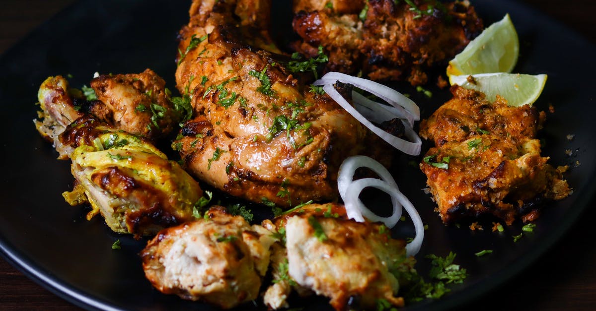 Making meat balls in chicken marinade - Fried Chicken on Black Ceramic Plate