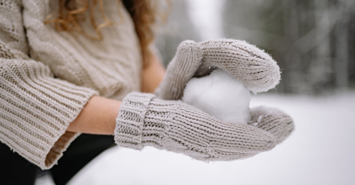 Making my meringues form peaks - Close-Up Photo of a Person with Knitted Gloves Forming a Snowball