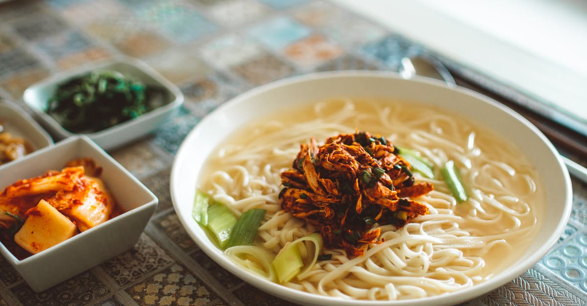 Making noodles in a wok - Traditional Asian Cuisine Serving on Table