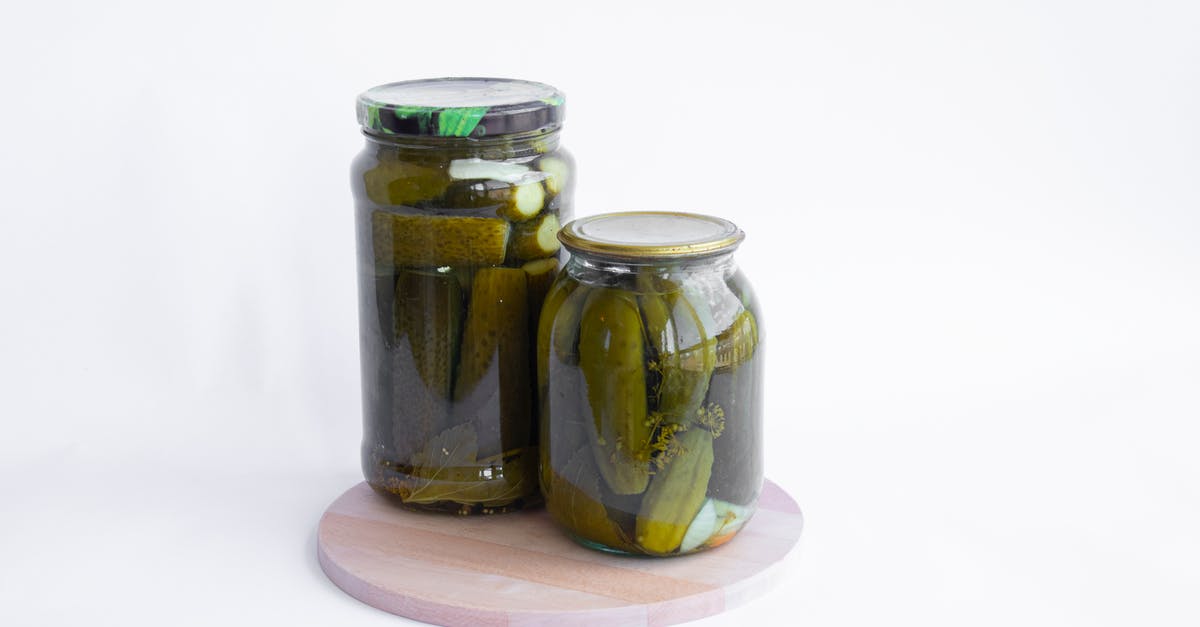Making pickles or preserves from hedgehog cucumbers (cucumis africanus) - Pickled Cucumbers on Glass Jars