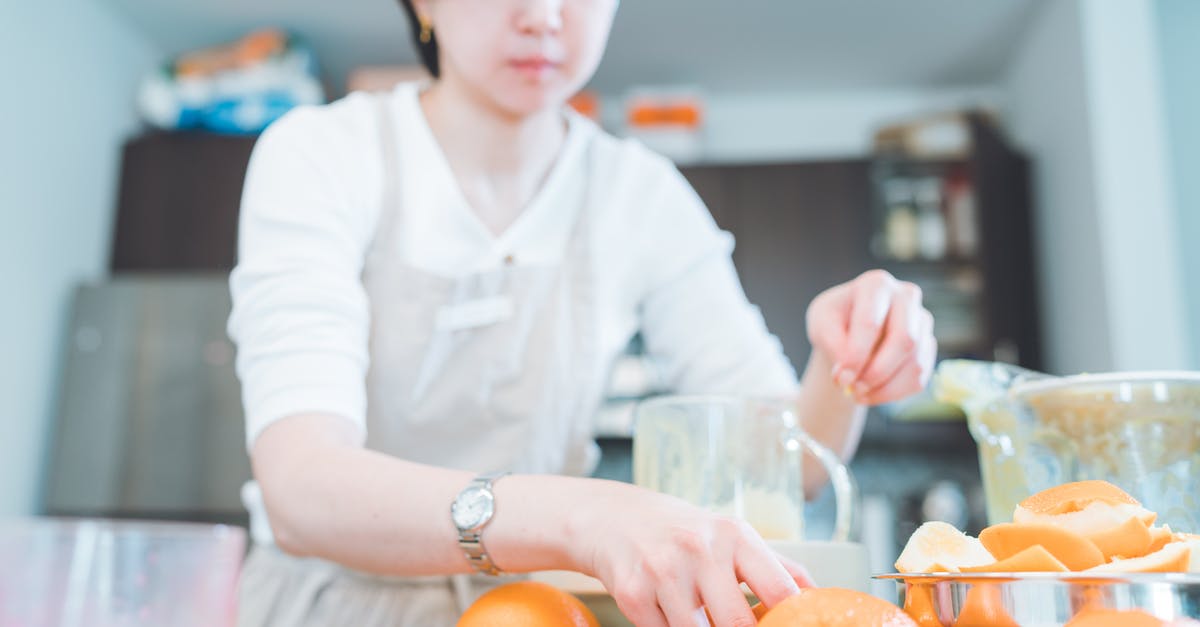 Making sorbet with fruit frozen before processing - A Woman Holding an Orange Fruit