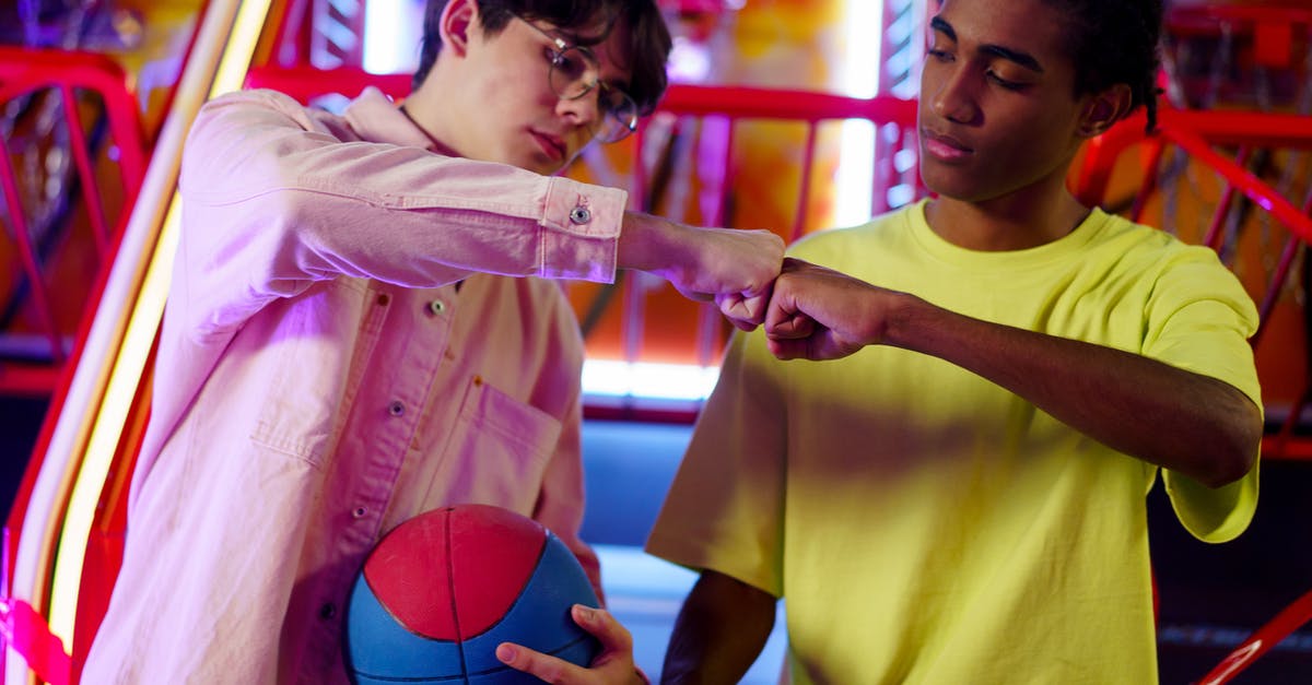 malted balls centers - Men Fist Bumping in an Amusement Center