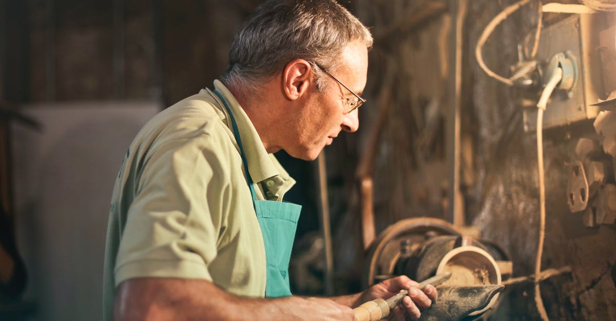 Manual Grinder/Food processor - Senior male turner working on lathe machine in workshop