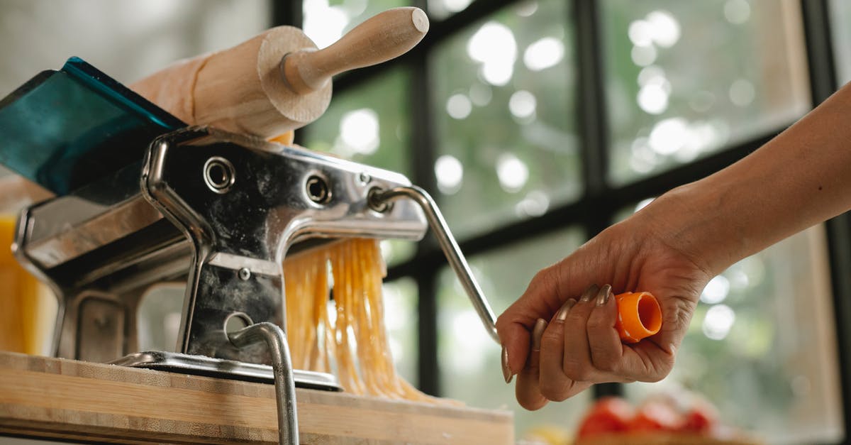 Manual noodle press pasta maker sticking - Crop woman using pasta machine