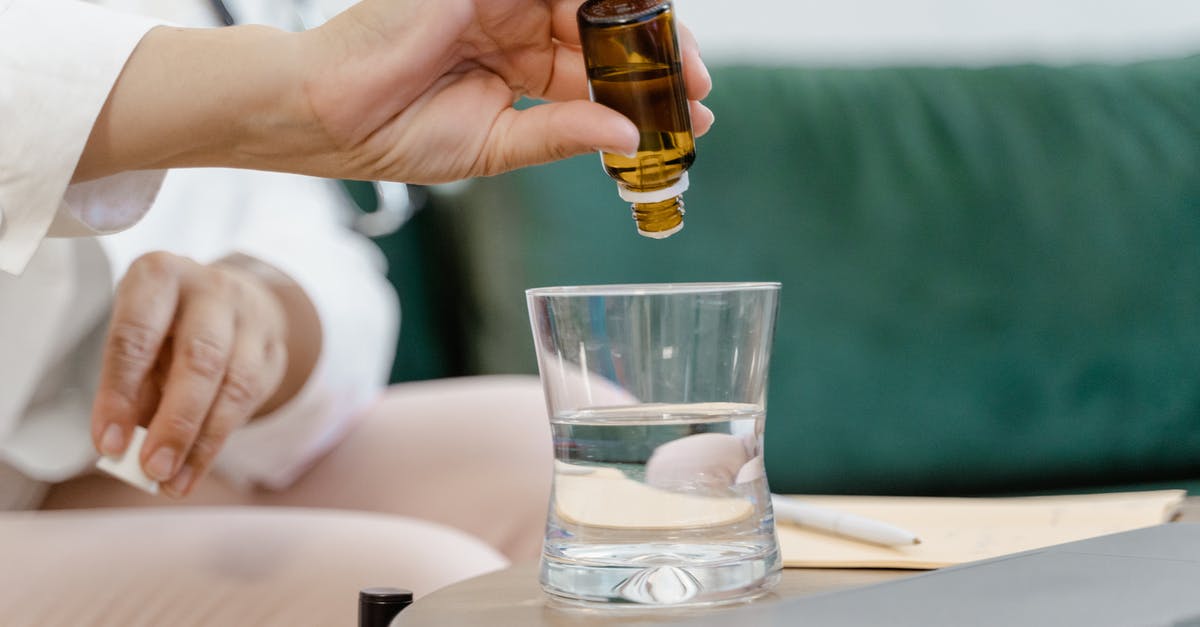 Marinades: Water vs Oil - Person Holding Clear Drinking Glass With Brown Liquid