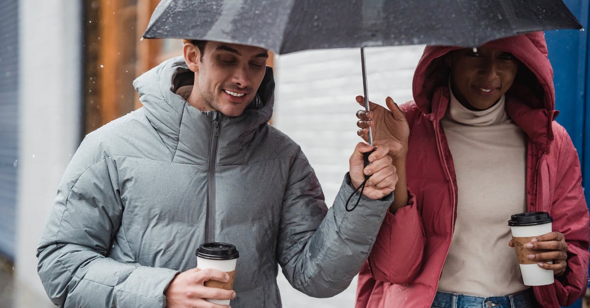 Mashed potato: start with hot water or cold water? - Smiling diverse couple walking with umbrella in rainy day