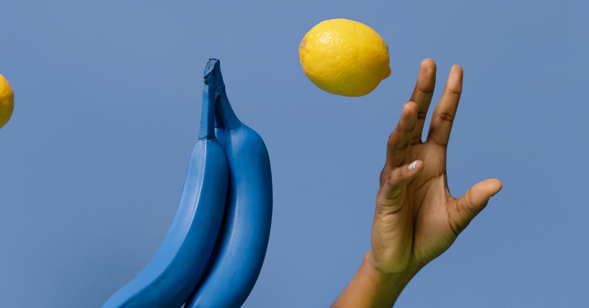 Mashing bananas for Muffins: By hand or with blender? - Close-Up Shot of a Person Holding a Lemon and Bananas