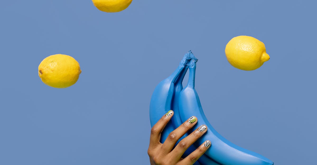 Mashing bananas for Muffins: By hand or with blender? - Close-Up Shot of a Person Holding Blue Bananas