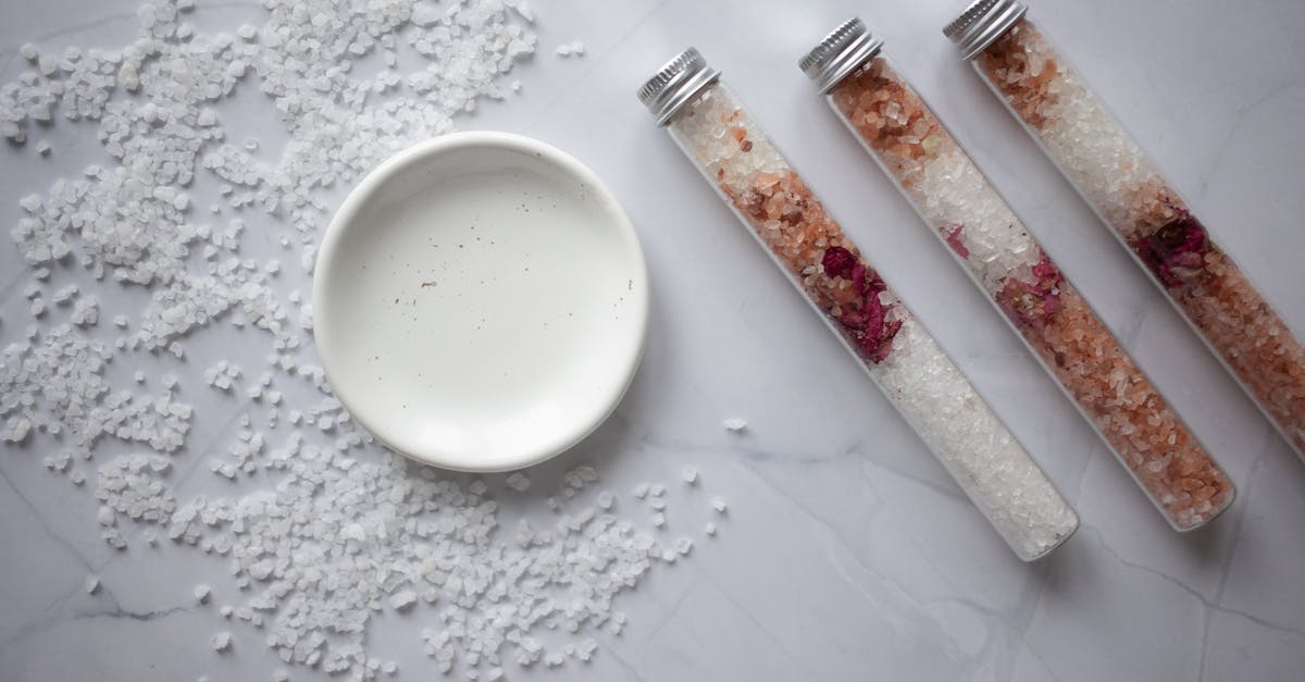 Mason jar stuck inside another - Set of salt for bath placed on marble table